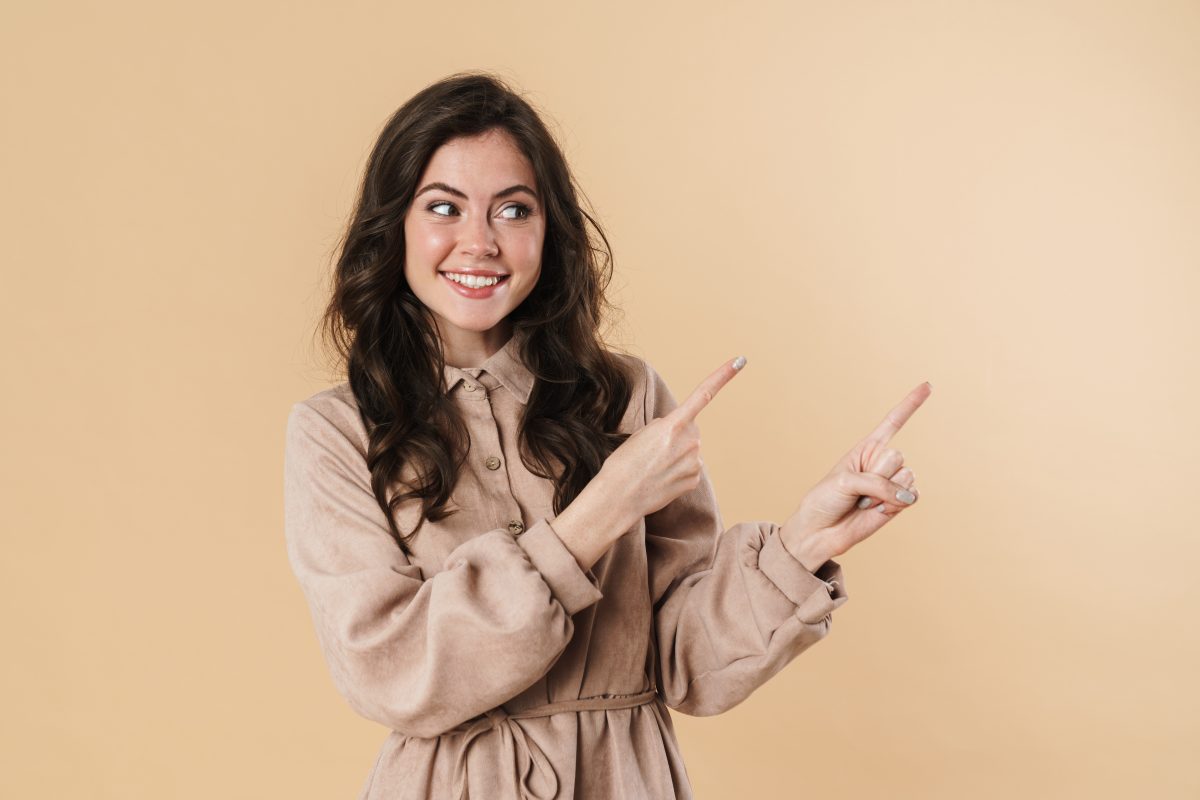 Image Of Cheerful Attractive Woman Smiling And Pointing Fingers