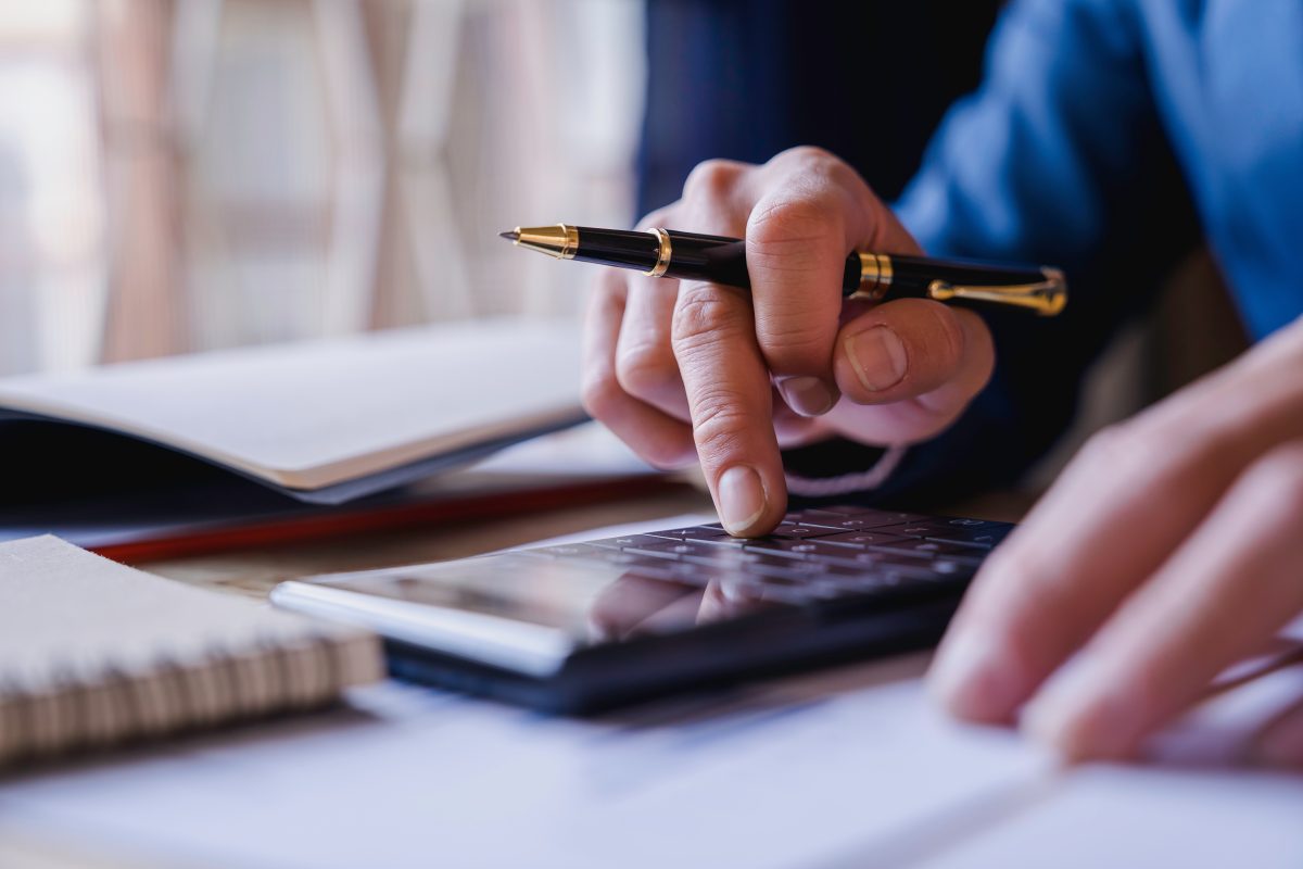 Businessman Working In The Office With Using A Calculator To Cal