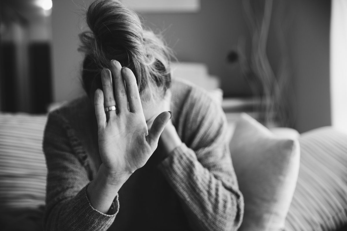 Lonely, Unhappy Woman With Her Hand Outstretched Sitting Alone On The Floor Feels Disappointed And Depressed.