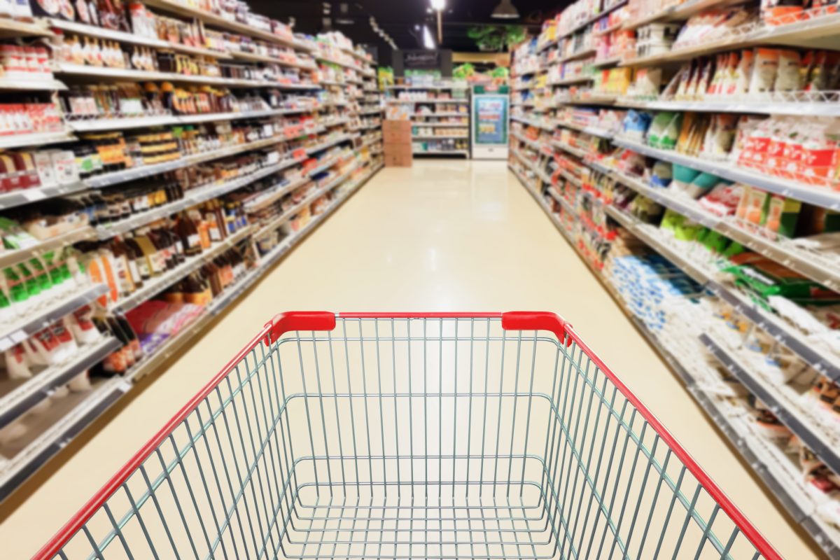 Supermarket Aisle With Empty Shopping Cart Business Concept