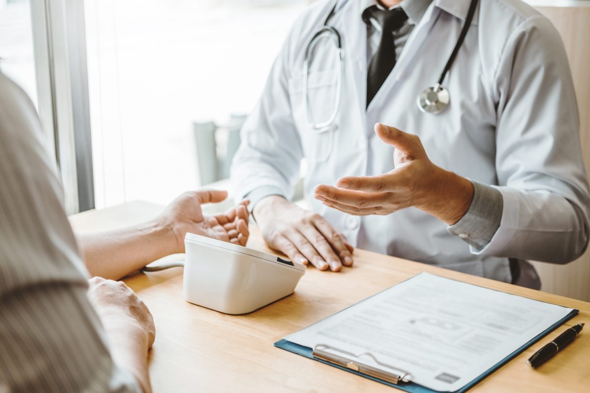 Doctor Measuring Arterial Blood Pressure With Man Patient On Arm